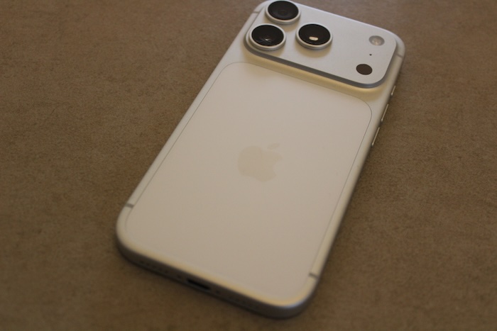 The back of the iPhone 17 sports three camera lenses and a new camera plateau